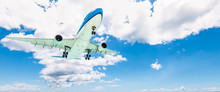 Airplane In The Sky. Clouds Background. Business And Travel Concept.
