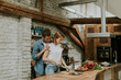 © BGStock72 - Lovely cheerful couple cooking dinner together and having fun at rustic kitchen