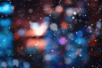 city lights snow glow background blurred / cityscape blurred bokeh, snowy weather seasonal background winter December