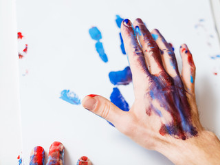 Art therapy class school. Man hand closeup. Paint print on white paper. Recreation relaxation painting. Hobby education.