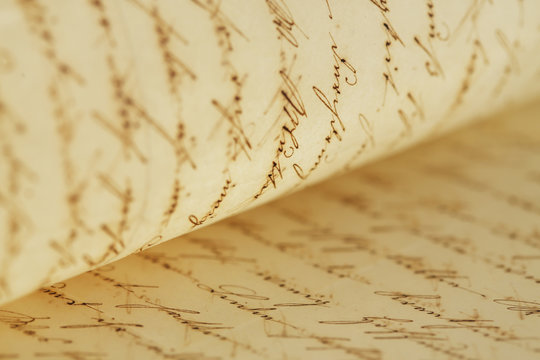 closeup of old handwriting; vintage paper background