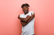 © Asier - Young african black man hugs himself, smiling carefree and happy.