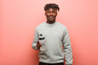 © Asier - Young fitness black man holding a water bottle happy, smiling and cheerful.
