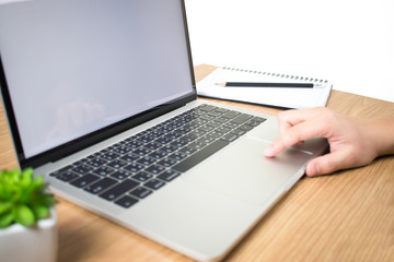 Poster - Women who use laptops with blank white screens on modern wooden tables. White background. Side view.