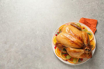 Sticker - Platter of cooked turkey with garnish on grey background, top view. Space for text