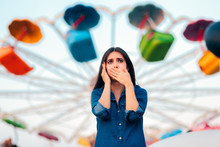 Woman Having Motion Sickness On Spinning Ferris Wheel Background