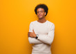 © Asier - Young african american man over an orange wall crossing arms, smiling and relaxed