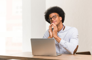 Wall Mural - Young black man using his laptop devising a plan