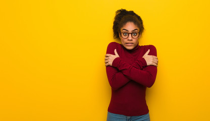 Wall Mural - Young black african american girl with blue eyes going cold due to low temperature