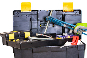 Wall Mural - Plumber or carpenter tool box isolated. Black plastic tool kit box with assorted tools and a hand with glove holding a big screw with a big pipe wrench. Isolated on a white background.