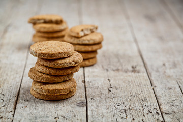 Wall Mural - Stacks of fresh baked oat cookies on rustic wooden table background.