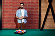 © Westend61 - Portrait of serious man at billiard table