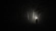 Darkness around a man with a flashlight
