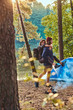 © Fxquadro - Young romantic couple have fun in summer forest near their tent. Man is holding woman, she hug him.