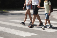 Father Holding Hands With His Kids While On Pedestrian Crossing