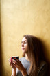 © Kiryl Lis - Young pretty girl with long hair drinking coffee or tea  in the cafe.