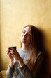 © Kiryl Lis - Young pretty girl with long hair drinking coffee or tea  in the cafe.