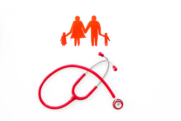 Wall Mural - Stethoscope and paper figure for family doctor set on white background top view