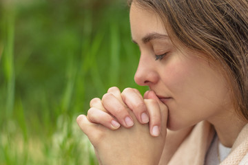 Wall Mural - Christian worship and praise. A young woman is praying in the morning.