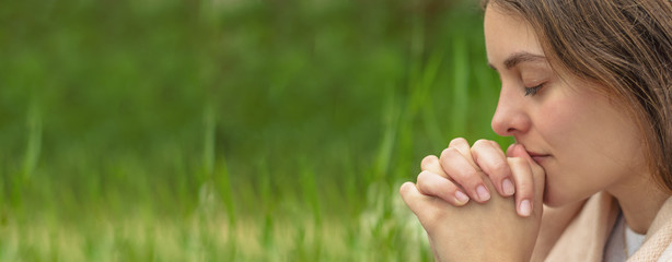 Wall Mural - Christian worship and praise. A young woman is praying in the morning.