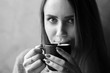 © Kiryl Lis - Monochrome portrait of young attractive girl with long hair and lips in the foam. Girl holding cup of cappuccino and drinking coffee in the cafe.