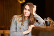© Kiryl Lis - Young pretty girl with long hair drinking coffee or tea  in the cafe.