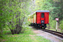 The Back Of The Train With A Red Carriage At The End Of The Road Through A Beautiful Landscape, Railway.