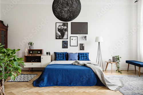 Black Chandelier In Navy Blue Bedroom In Tenement House