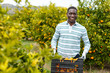 © JackF - African-American farmer with box of mandarins
