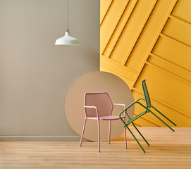 Pink and green metal chair concept in the room, brown and yellow background.