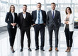 © opolja - Full length confident business team stands in office.