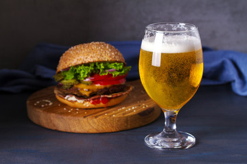 Wall Mural - Glass of beer and burger. Beer and food concept