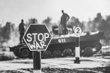 Creative Badge - Stop Wars. Concept - No War, Stop Military Operations, World Peace. Stop War Sign On The Background Of Military Equipment.