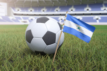 Nicaragua flag in stadium field with soccer football