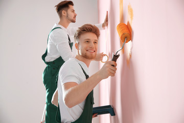 Poster - Professional decorators painting wall indoors. Home repair service