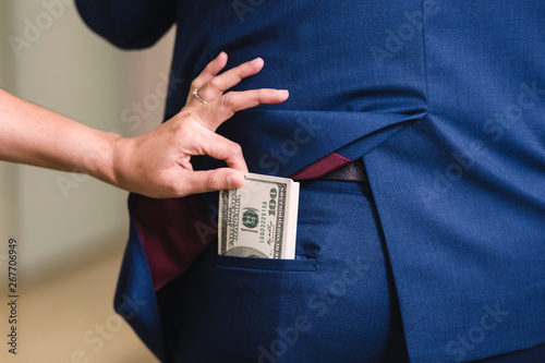Fotomural Woman is stealing money from businessman
