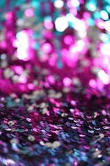 Wall Mural - Sequins   multicolored blurred bokeh background.Shine fabric sequin. fabric in cold tones.Texture scales with Sequins close-up.Shiny texture sequin material