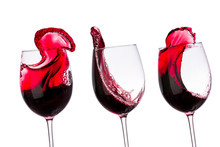 Red Wine In Glasses With Splashes On A White Background Isolated