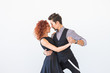 © satura_ - Social dance, bachata, kizomba, tango, salsa, people concept - Young couple dancing over white background