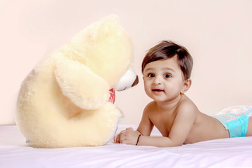 cute indian baby child playing with toy