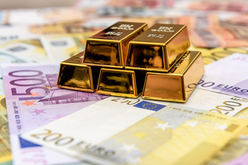 Pyramid of gold bullion on euro banknotes background