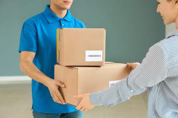 Woman receiving boxes from delivery man