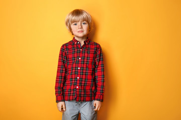 cute little boy on color background