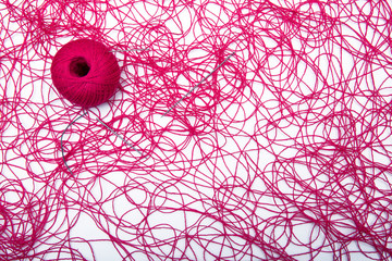 Wall Mural - A ball of red thread and sewing needles on a white background