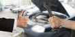 Man wearing suit showing thumb up to mechanic