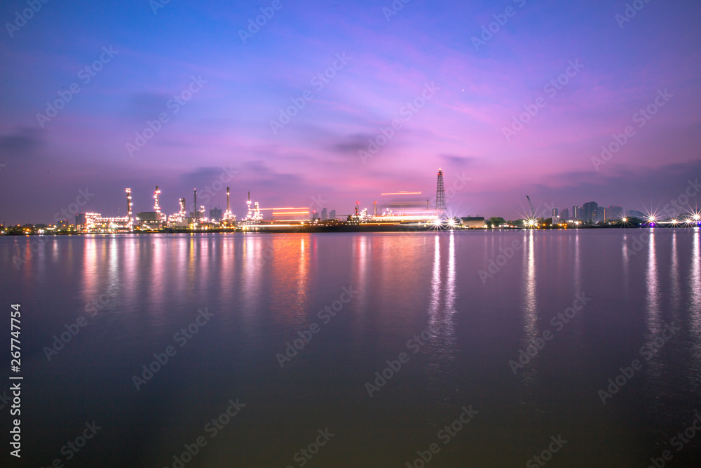 The blurred background of nature along the river, with views of the cargo ship, oil refinery, sunrise and beautiful sky in the morning - obrazy, fototapety, plakaty 