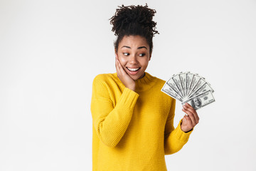 Wall Mural - African excited emotional happy woman posing isolated over white wall background holding money.