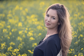 Beautiful woman in rapeseed field