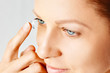 © Olesia - Young woman puts contact lens in her eye. Eyewear, eyesight and vision, eye care and health, ophthalmology and optometry concept, selective focus