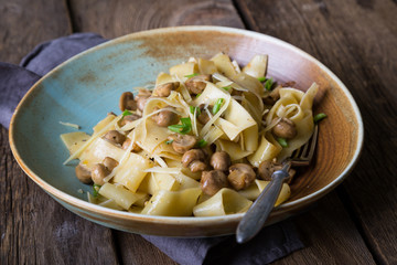 Wall Mural - Simple rustic noodles with fried mushrooms and greens